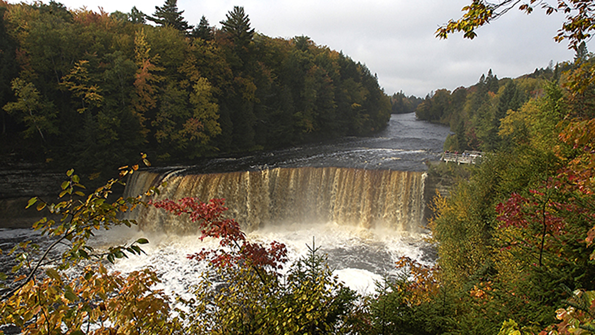 The Upper Peninsula Waterfall That Pours 50,000 Gallons Per Second and Glows Like Dark Amber